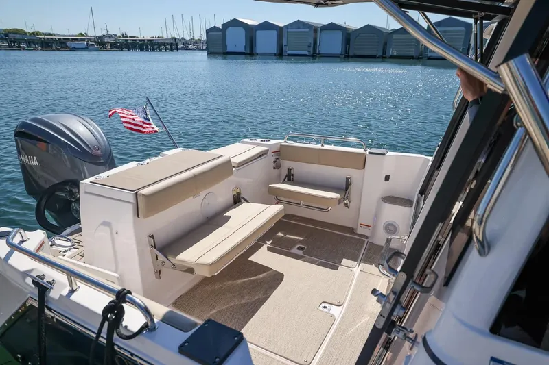 Slide: The Image of 2026 Cutwater C-248 Coupe boat interior with seating, docked by marina. - 5