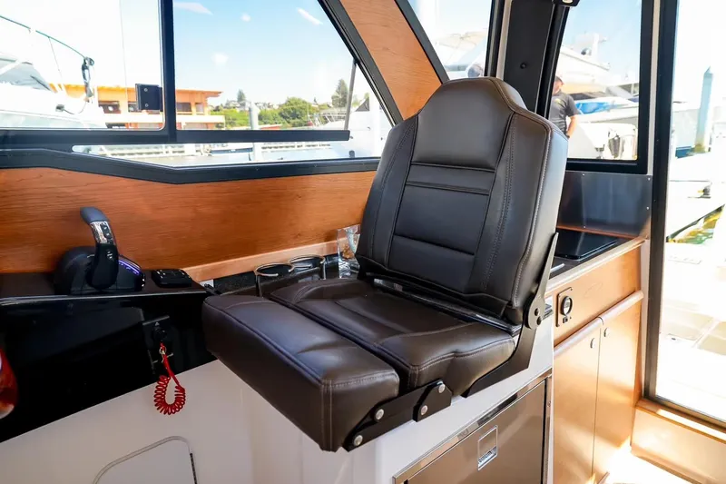 Slide: The Image of 2026 Cutwater C-248 Coupe interior with leather captain's chair and modern controls. - 9