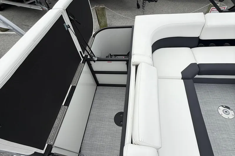 Slide: The Image of 2026 Berkshire 23CL STS 2.75 boat interior with white seating and storage compartment. - 10