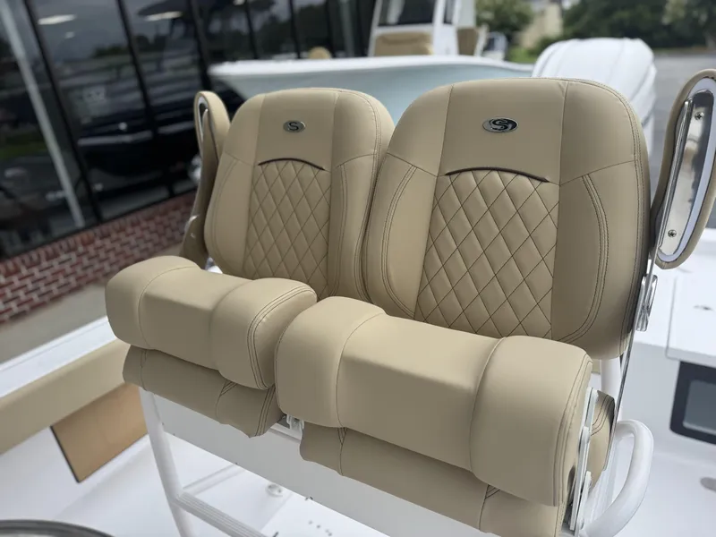 Slide: The Image of Luxurious seating on 2026 Sportsman Masters 247OE Bay Boat, featuring tan upholstery and diamond stitching. - 10