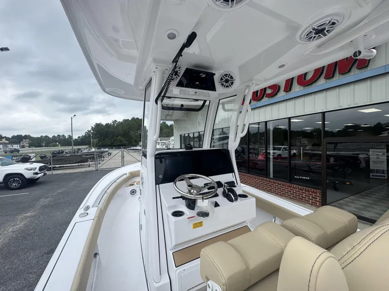 Slide: The Image of 2026 Sportsman Masters 247OE Bay Boat interior with steering console and seating. - 11