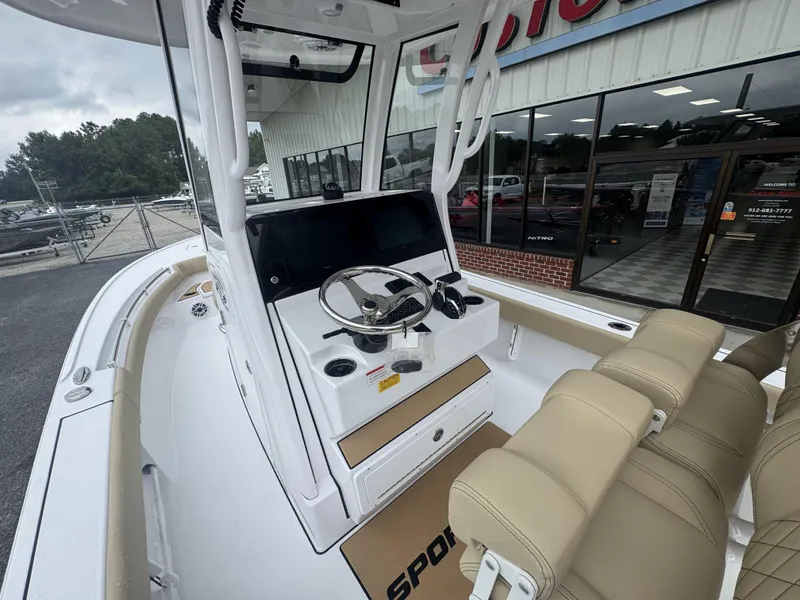 Slide: The Image of 2026 Sportsman Masters 247OE Bay Boat interior with steering console and seating. - 12