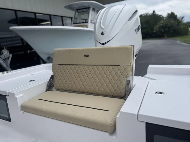 Slide: The Image of 2026 Sportsman Masters 247OE Bay Boat with beige diamond-stitched seating and Yamaha engine. - 14