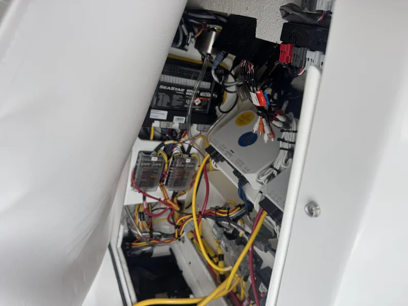 Slide: The Image of Electrical wiring and components inside a 2026 Sportsman Masters 247OE Bay Boat. - 23