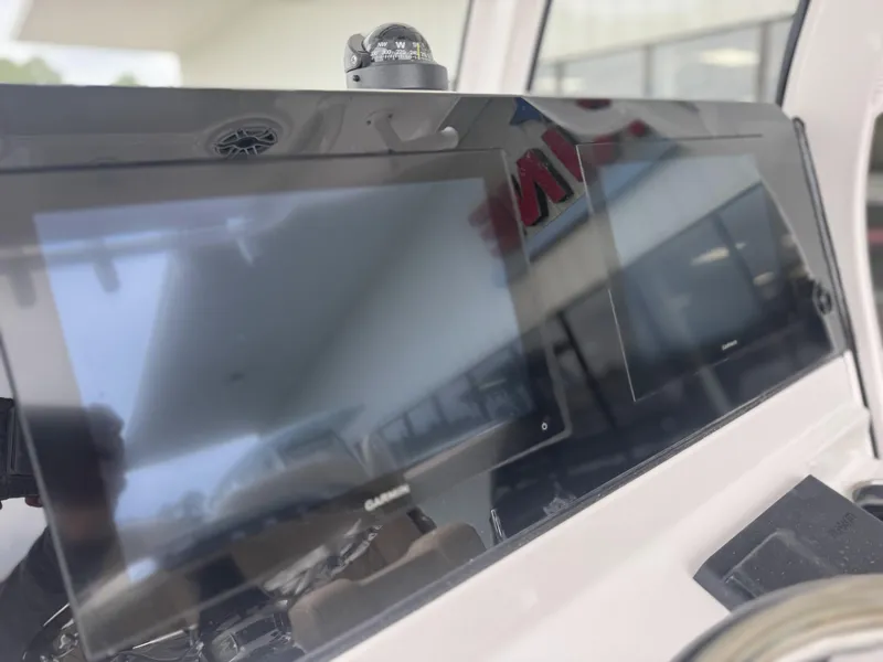 Slide: The Image of 2026 Sportsman Masters 247OE Bay Boat dashboard with Garmin display and compass. - 30