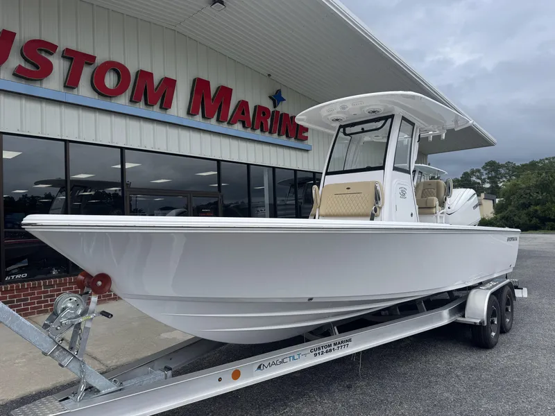 Slide: The Image of 2026 Sportsman Masters 247OE Bay Boat on trailer at Custom Marine dealership. - 6