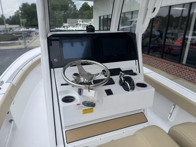 Slide: The Image of 2026 Sportsman Masters 247OE Bay Boat helm with steering wheel and dual displays. - 9