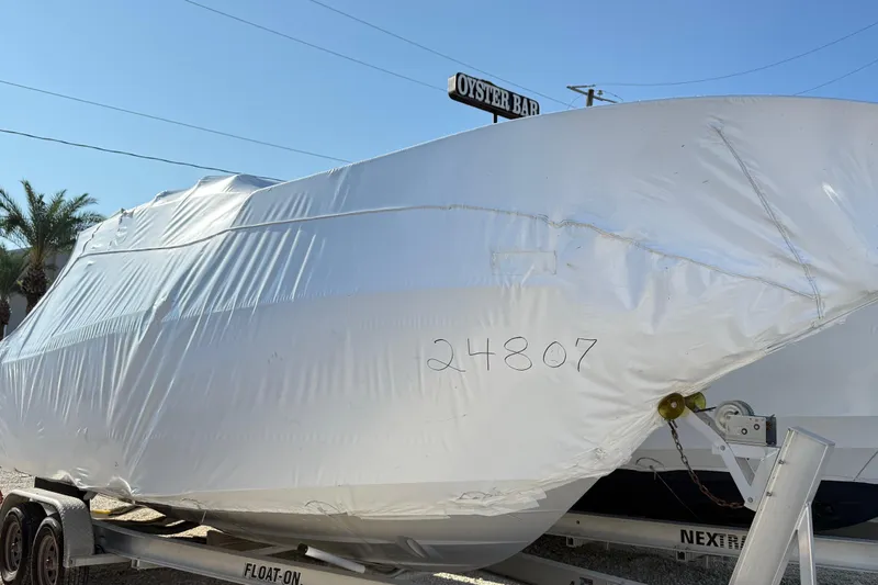 Slide: The Image of 2026 Cutwater C-248 Coupe boat wrapped in protective cover on trailer. - 17