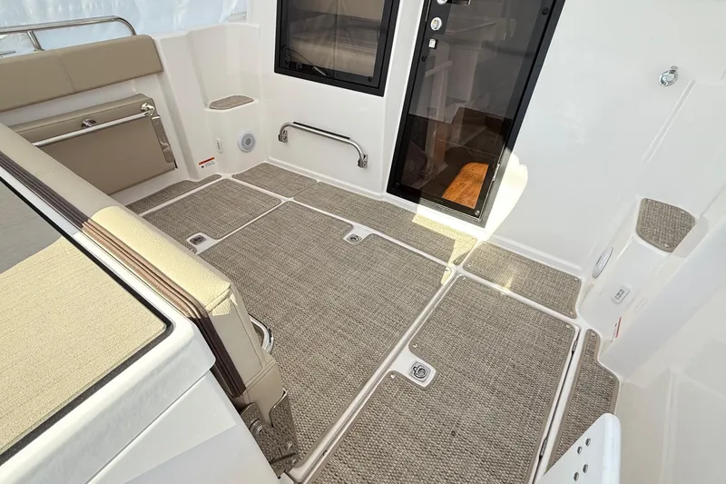 Slide: The Image of 2026 Cutwater C-248 Coupe interior with beige seating and carpeted flooring. - 20