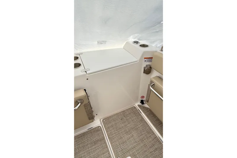 Slide: The Image of 2026 Cutwater C-248 Coupe interior with beige seating and storage compartment. - 22