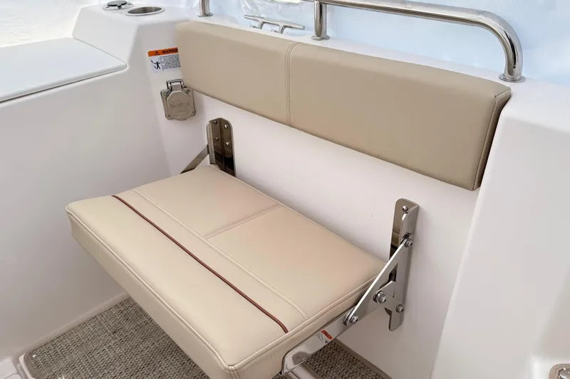 Slide: The Image of 2026 Cutwater C-248 Coupe boat seat with beige upholstery and stainless steel hardware. - 25