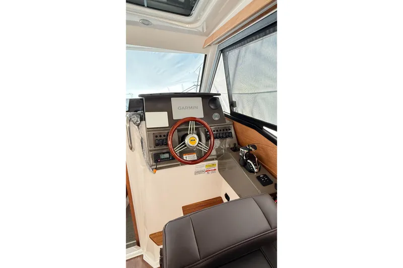 Slide: The Image of 2026 Cutwater C-248 Coupe helm with Garmin navigation, wood accents, and modern controls. - 28