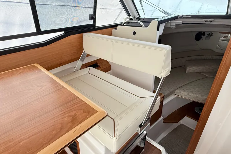 Slide: The Image of 2026 Cutwater C-248 Coupe interior with white seating and wooden table. - 39