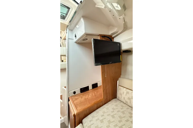 Slide: The Image of Interior of 2026 Cutwater C-248 Coupe featuring a mounted TV and cozy seating area. - 45