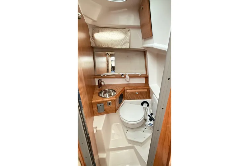 Slide: The Image of 2026 Cutwater C-248 Coupe bathroom with wood accents, compact sink, and toilet. - 48