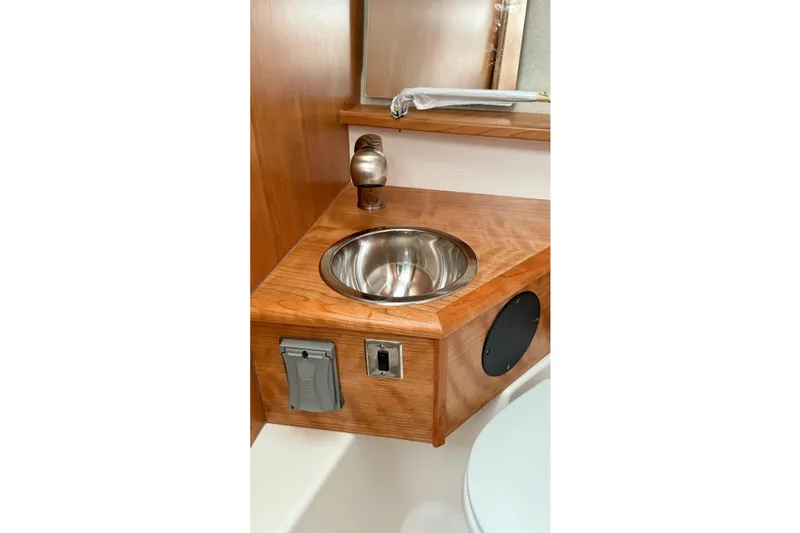 Slide: The Image of 2026 Cutwater C-248 Coupe bathroom with wooden vanity and stainless steel sink. - 49