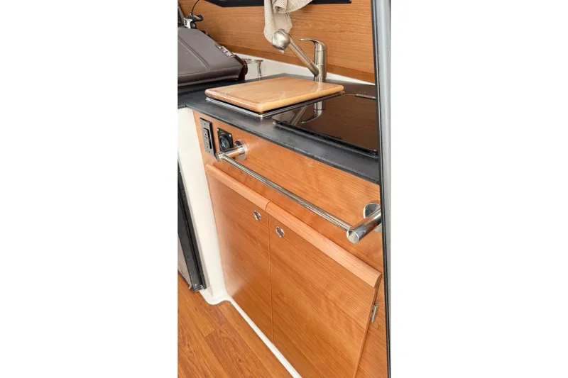 Slide: The Image of 2026 Cutwater C-248 Coupe interior kitchen with wooden cabinetry and modern sink. - 60