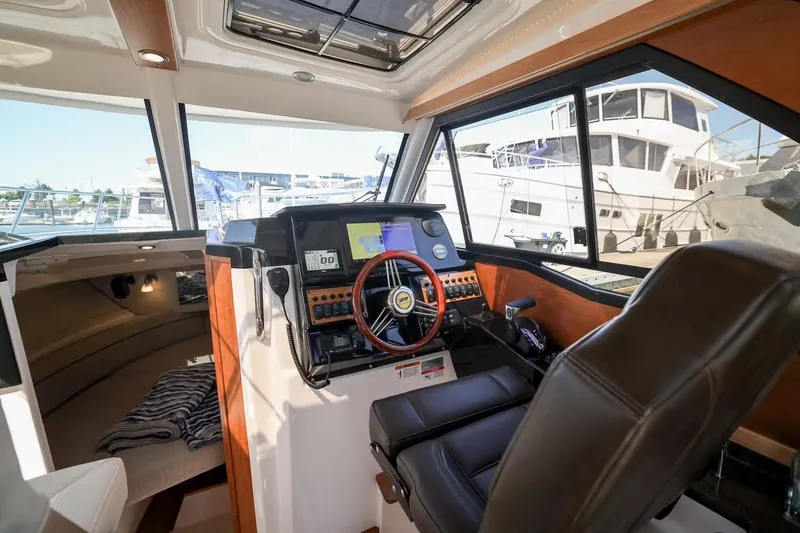 Slide: The Image of Interior of 2026 Cutwater C-248 Coupe boat with modern helm and navigation equipment. - 8