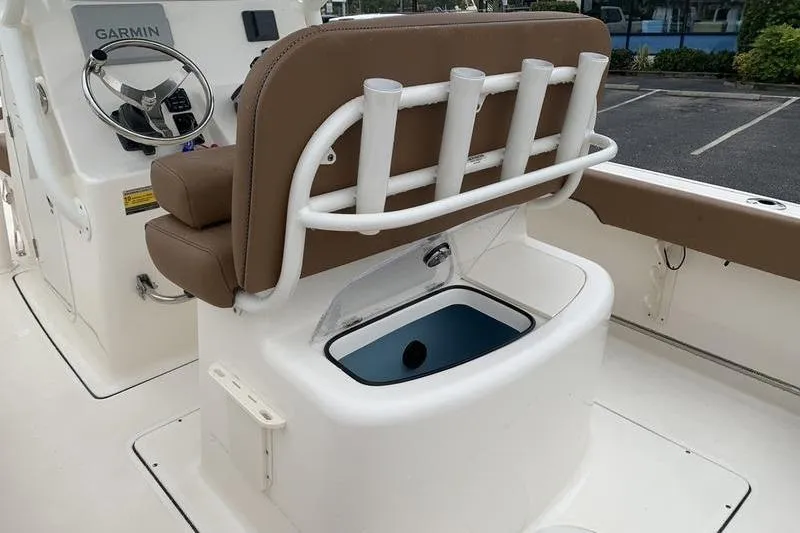 Slide: The Image of 2025 Pionee Sportfish 222 boat interior with rod holders and Garmin steering console. - 12
