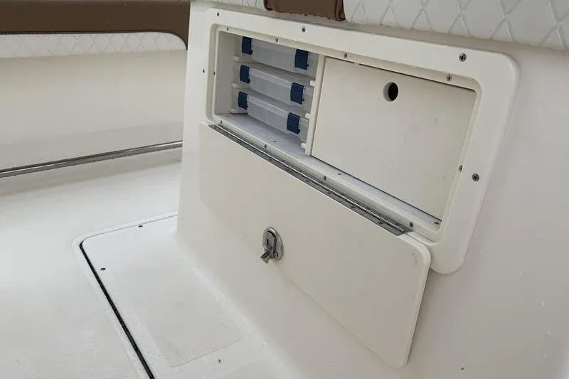 Slide: The Image of Storage compartment on 2025 Pionee Sportfish 222 boat, featuring organized tackle boxes. - 14