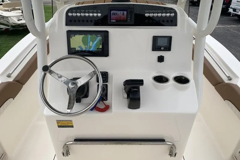 Slide: The Image of 2025 Pionee Sportfish 222 boat dashboard with steering wheel, navigation screens, and controls. - 20