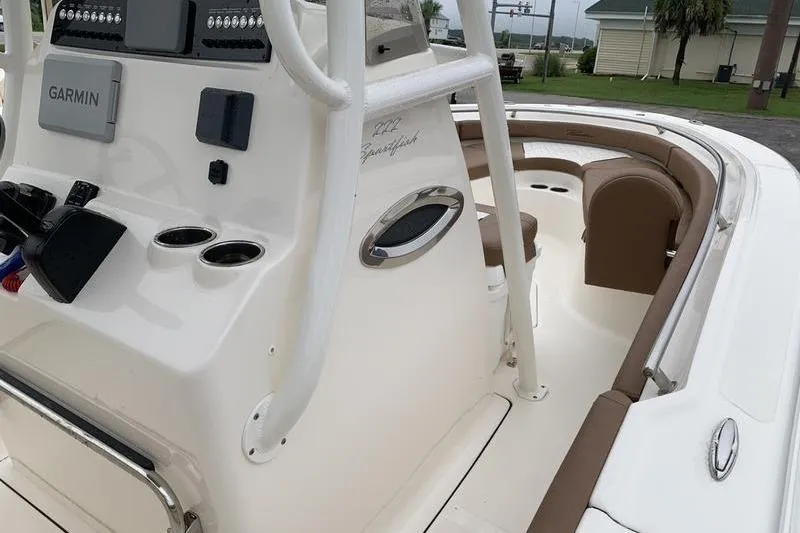 Slide: The Image of 2025 Pionee Sportfish 222 boat interior with Garmin navigation system and seating area. - 26
