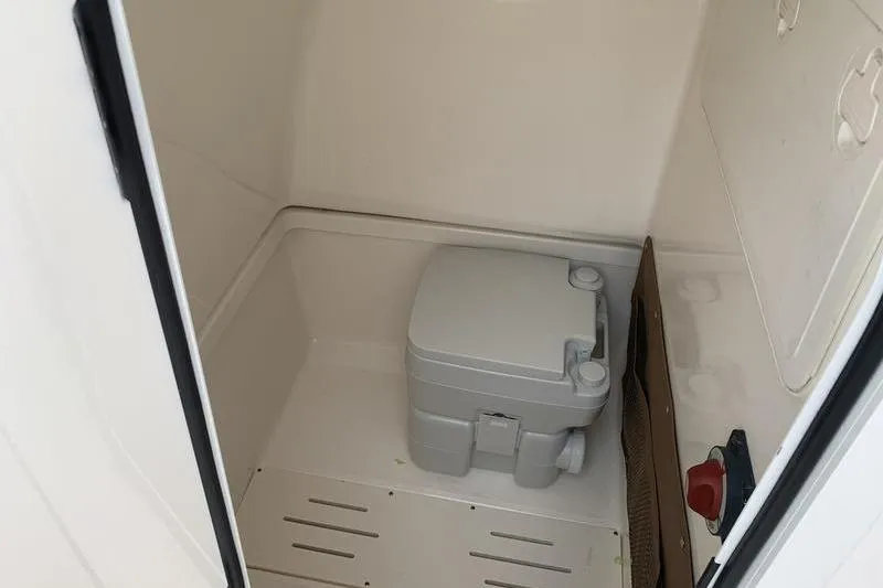 Slide: The Image of Portable toilet inside 2025 Pionee Sportfish 222 boat cabin. - 29