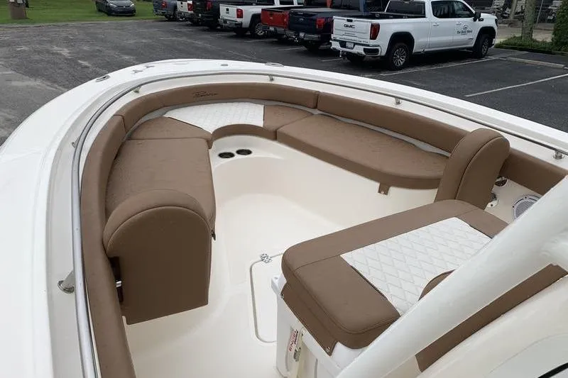 Slide: The Image of 2025 Pionee Sportfish 222 boat with spacious tan seating in a parking lot. - 30
