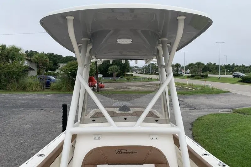 Slide: The Image of 2025 Pionee Sportfish 222 boat with T-top, parked on a driveway. - 33