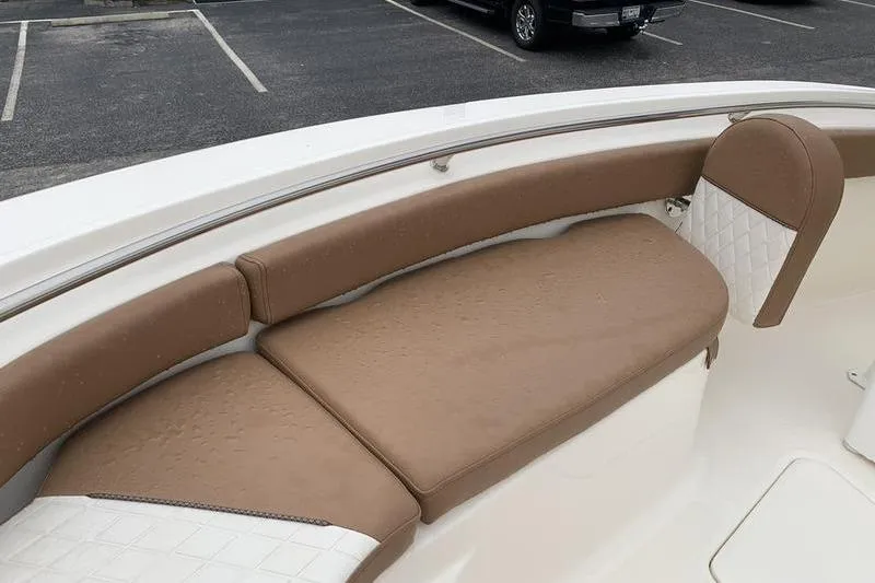 Slide: The Image of 2025 Pionee Sportfish 222 boat interior with tan cushioned seating. - 34