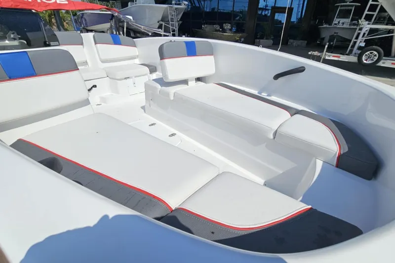 Slide: The Image of 2024 Tahoe T16 boat interior with white and gray seating, accented by red and blue details. - 11