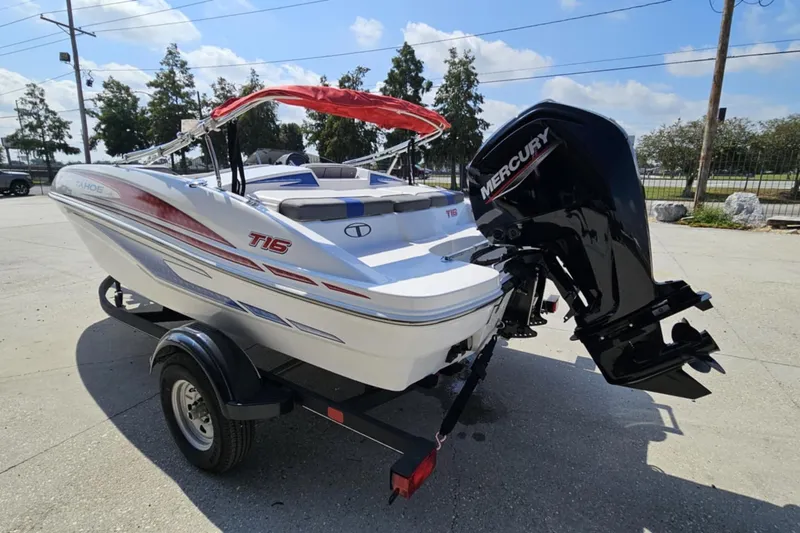 Slide: The Image of 2024 Tahoe T16 boat with Mercury engine on trailer, parked outdoors. - 6