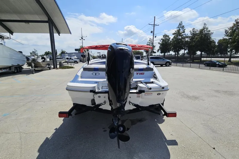 Slide: The Image of 2024 Tahoe T16 boat with outboard motor in a parking lot. - 7