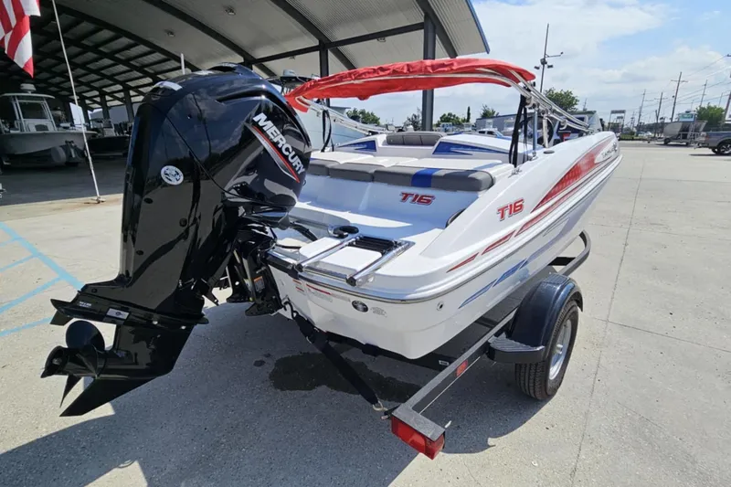 Slide: The Image of 2024 Tahoe T16 boat with Mercury outboard motor on trailer, parked outdoors. - 8
