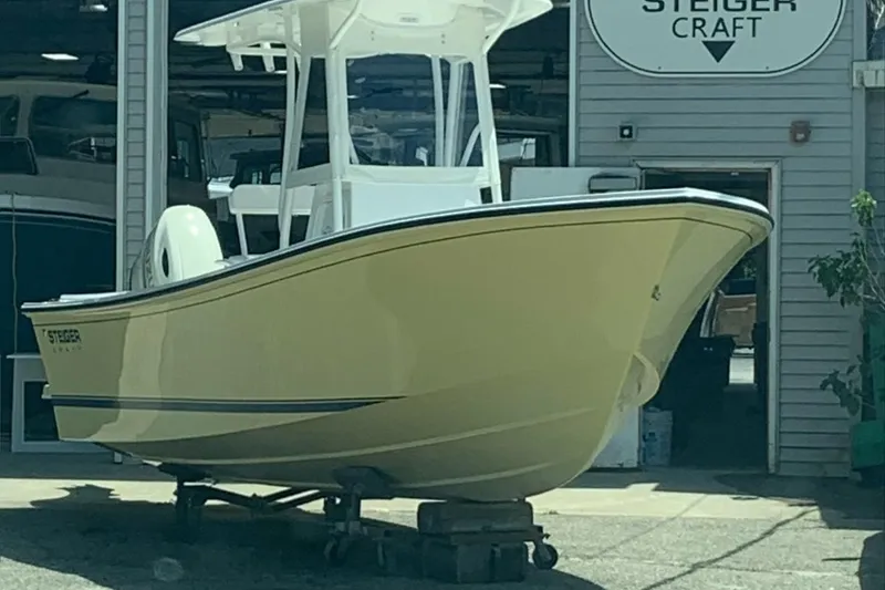 Slide: The Image of 2021 Steiger Craft 21 Tournament boat displayed outside a workshop. - 2