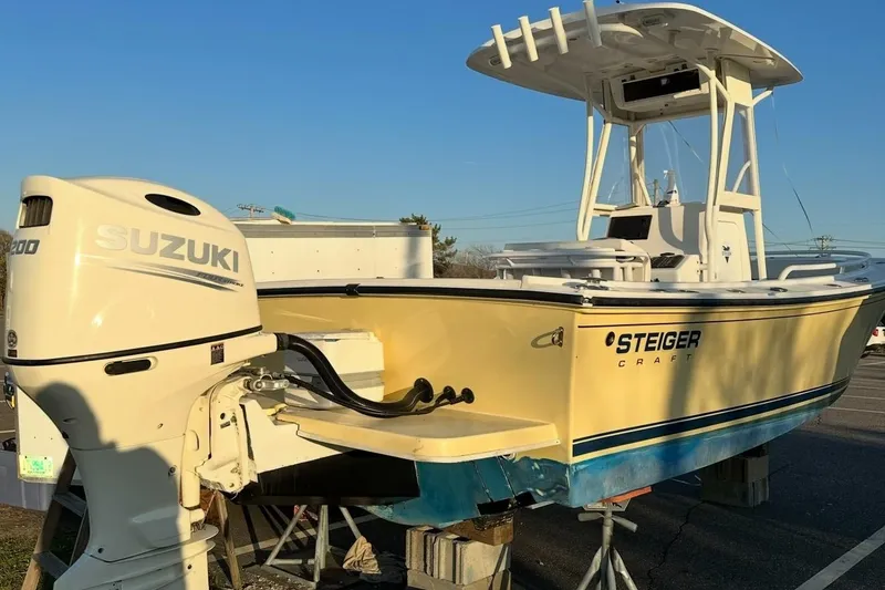 Slide: The Image of 2021 Steiger Craft 21 Tournament boat with Suzuki engine, parked outdoors. - 3