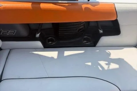 Slide: The Image of 2013 Nautique Super Air Nautique G23 interior with orange and white seating. - 10