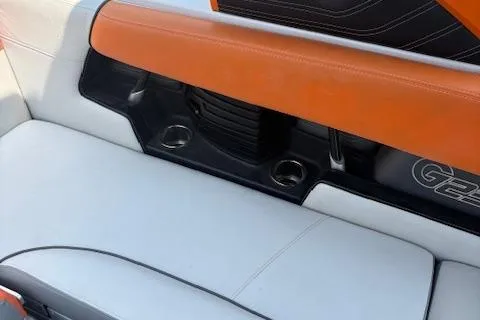 Slide: The Image of 2013 Nautique Super Air Nautique G23 interior with orange and white seating. - 11