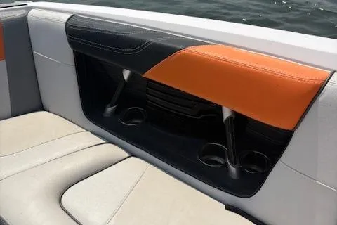 Slide: The Image of 2013 Nautique Super Air Nautique G23 interior seating with orange and black accents. - 13
