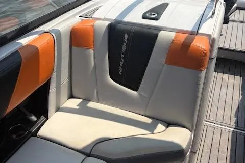 Slide: The Image of 2013 Nautique Super Air Nautique G23 interior with orange and white seating. - 14