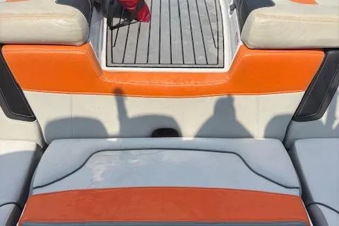 Slide: The Image of 2013 Nautique Super Air Nautique G23 boat interior with orange and gray seating. - 15