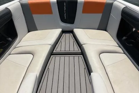 Slide: The Image of 2013 Nautique Super Air Nautique G23 boat interior with cushioned seating and sleek design. - 17