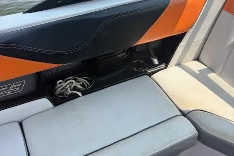 Slide: The Image of Interior seating of 2013 Nautique Super Air Nautique G23 boat with orange and gray accents. - 8