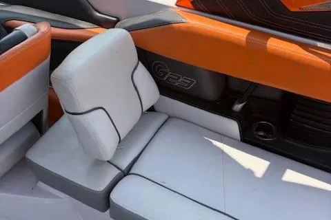 Slide: The Image of 2013 Nautique Super Air Nautique G23 interior with orange and white seating. - 9