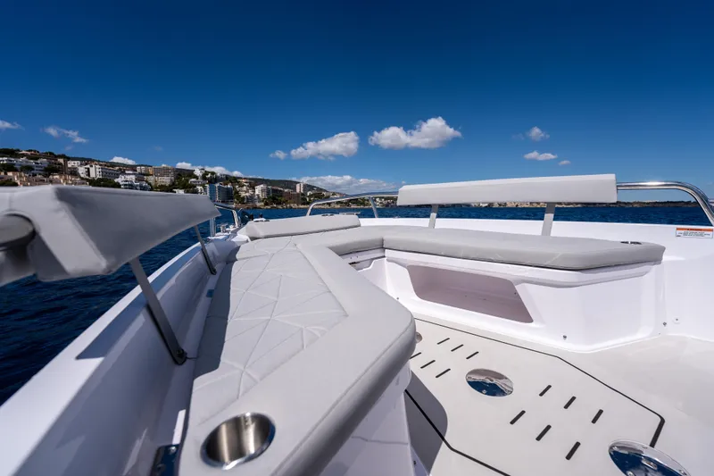 Slide: The Image of 2025 Axopar Sun-Top boat with dual Mercury outboard engines, sleek white deck design. - 13