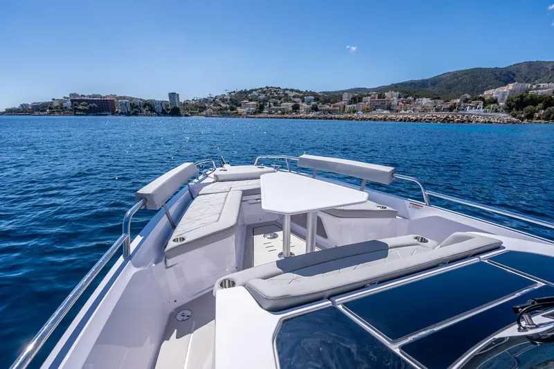 Slide: The Image of 2025 Axopar Sun-Top boat interior with compact toilet and control panel. - 16