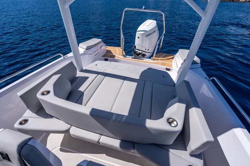 Slide: The Image of 2025 Axopar Sun-Top boat interior with woven fabric and wooden cup holder. - 19