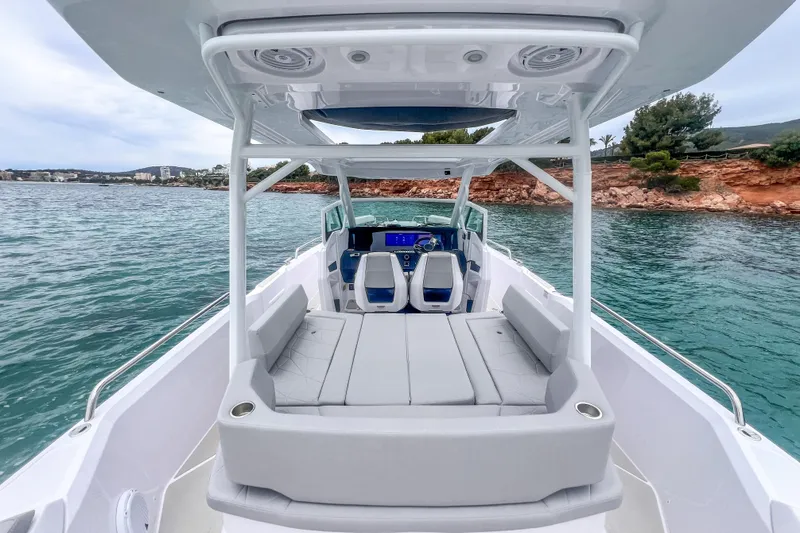 Slide: The Image of Interior seating area of 2025 Axopar Sun-Top boat with cushioned seats and metal supports. - 20