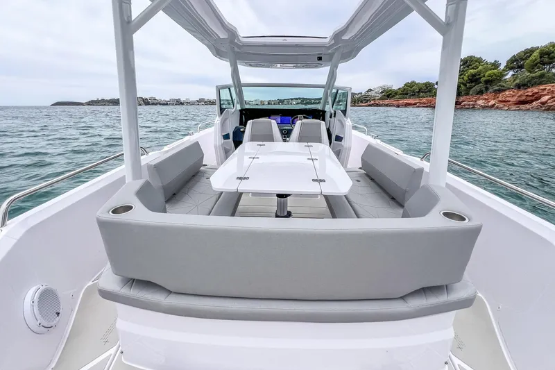 Slide: The Image of 2025 Axopar Sun-Top boat deck with cup holders and textured surface. - 21