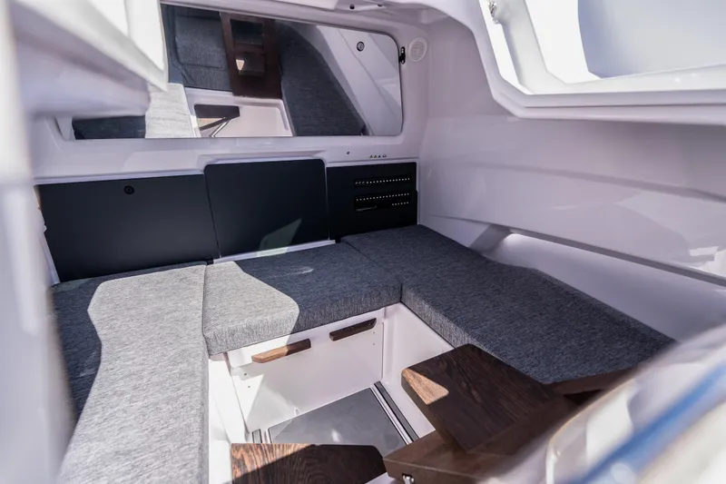 Slide: The Image of 2025 Axopar Sun-Top boat dashboard with steering wheel and dual Simrad displays. - 26